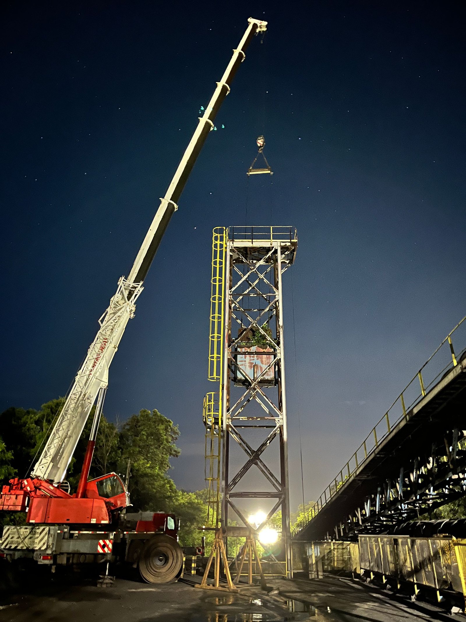 Crane and industrial structure during night installation work