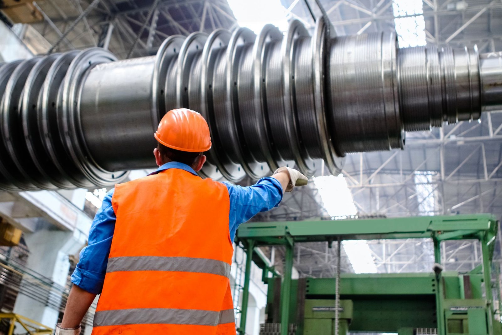Industrial worker assessing a large metal component